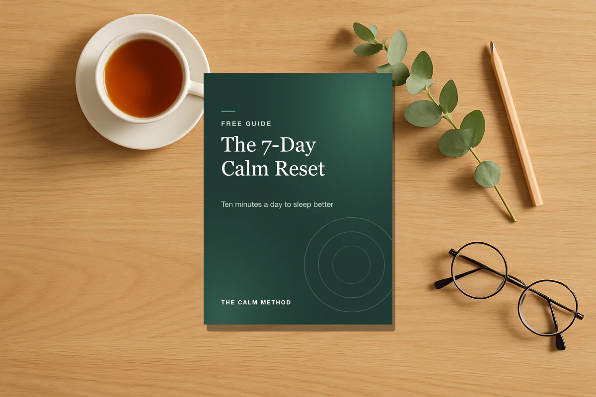 The 7-Day Calm Reset guide on a desk beside a cup of tea